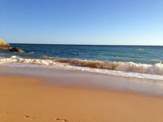 Sandstrand mit auslaufenden Wellen